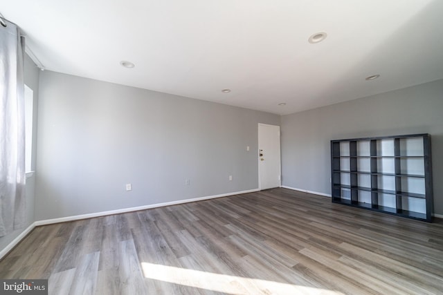 unfurnished room with hardwood / wood-style flooring