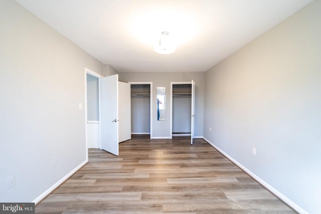 unfurnished bedroom featuring light wood-type flooring