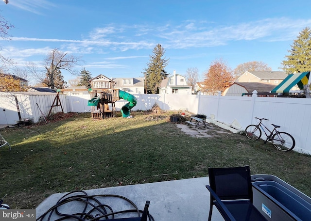 view of yard featuring a patio area and a playground