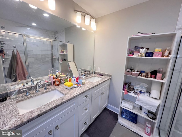 bathroom featuring vanity and a shower with door