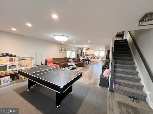 recreation room with light wood-type flooring and ceiling fan