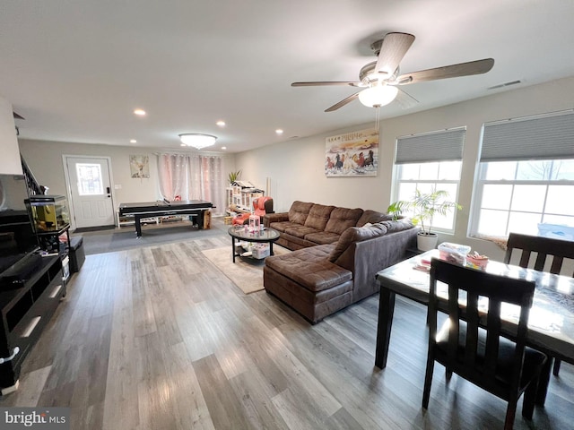 living room featuring hardwood / wood-style floors, ceiling fan, and pool table