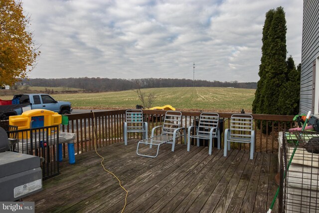 wooden deck with a rural view