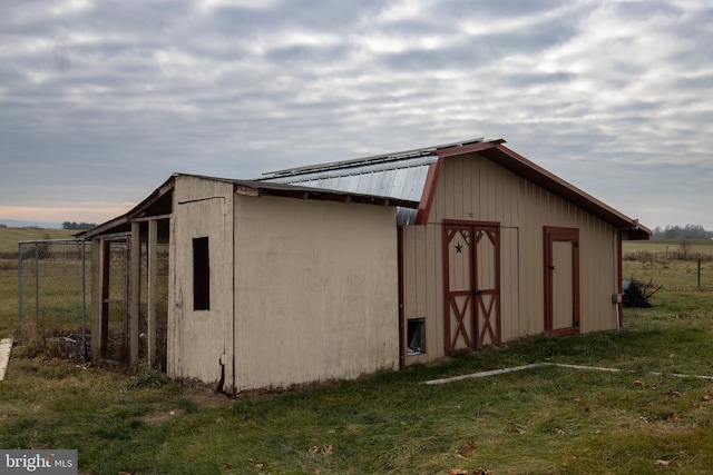 view of outdoor structure featuring a lawn