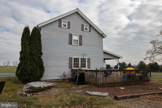 rear view of house featuring a deck