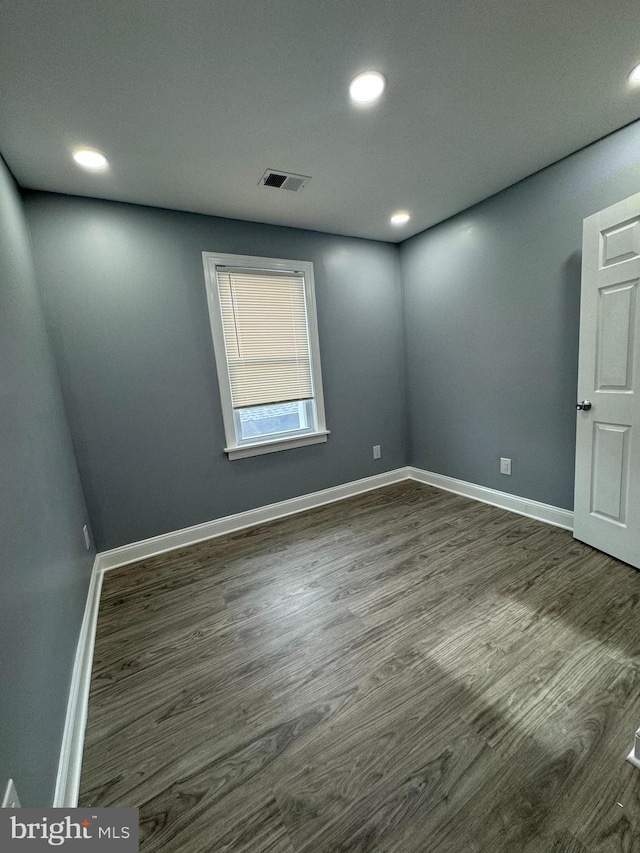 unfurnished room featuring dark hardwood / wood-style flooring