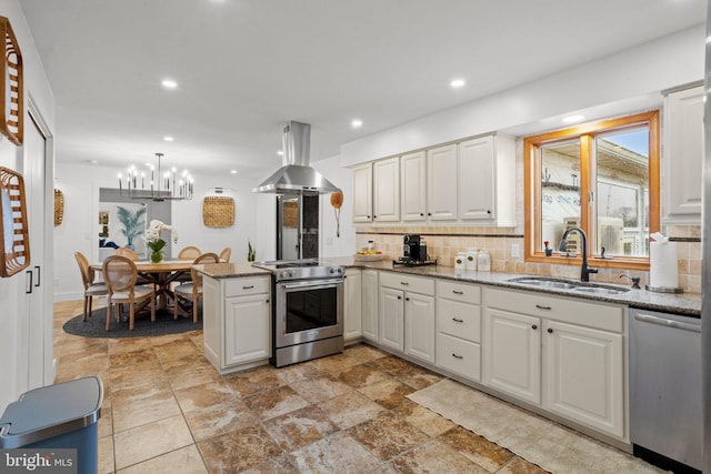 kitchen with island exhaust hood, kitchen peninsula, backsplash, stainless steel appliances, and sink