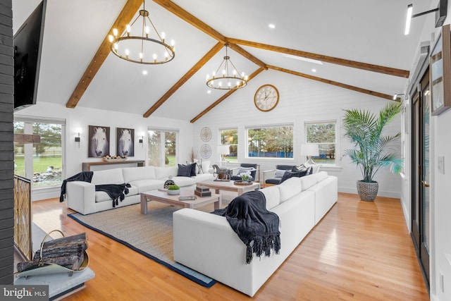 living room with beamed ceiling, high vaulted ceiling, light hardwood / wood-style floors, and an inviting chandelier