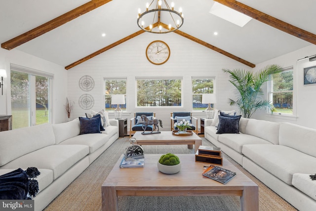 living room featuring plenty of natural light, high vaulted ceiling, beamed ceiling, and a notable chandelier