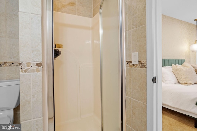 bathroom featuring toilet and an enclosed shower