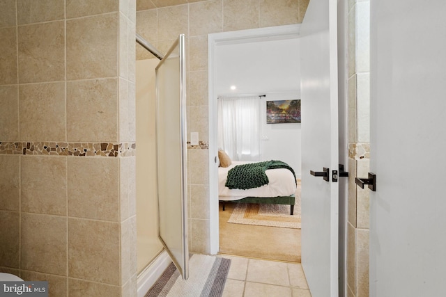 bathroom featuring tile patterned floors and a shower with door