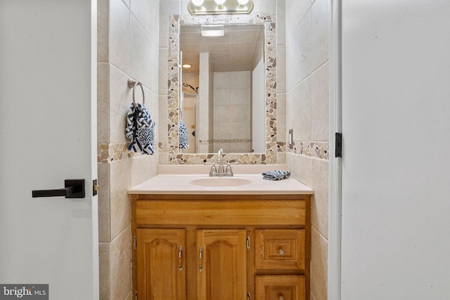 bathroom featuring vanity and tile walls