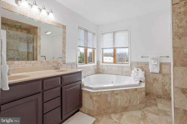 bathroom with tile patterned flooring, vanity, separate shower and tub, and tile walls