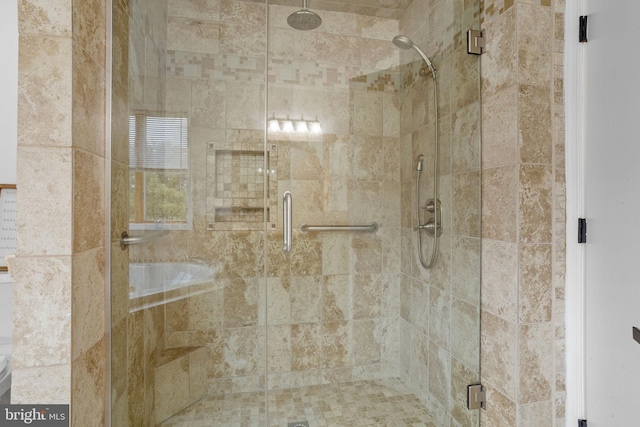 bathroom with a shower with door