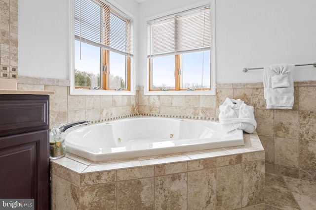 bathroom with a wealth of natural light and a relaxing tiled tub