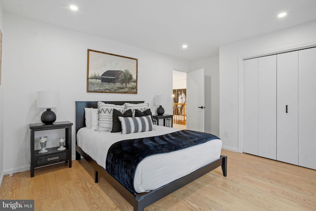 bedroom featuring light wood-type flooring and a closet