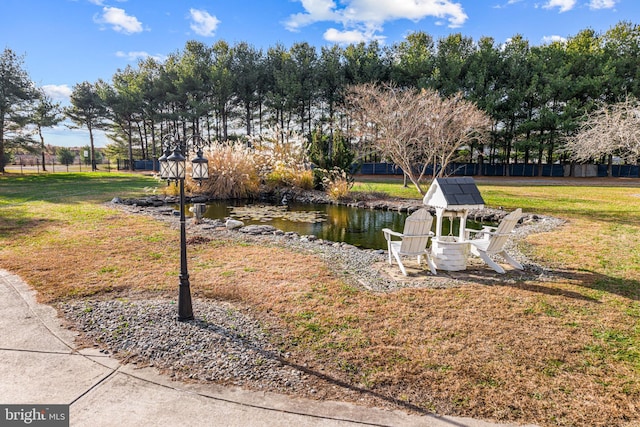 surrounding community featuring a yard and a water view