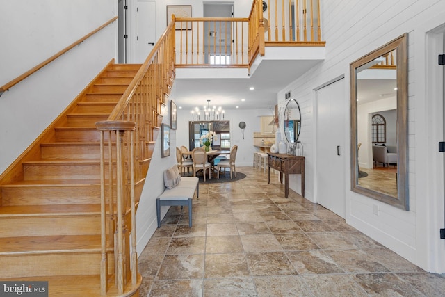 entrance foyer featuring a high ceiling and an inviting chandelier