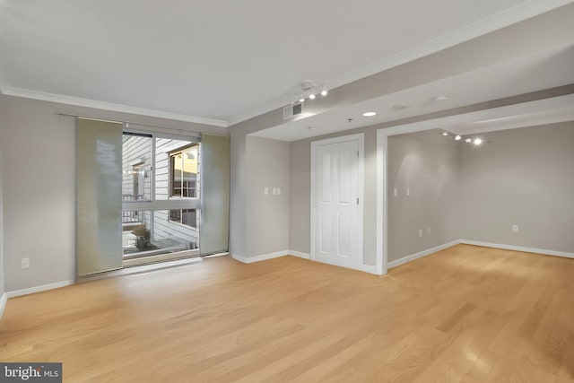 unfurnished room with light hardwood / wood-style flooring and ornamental molding