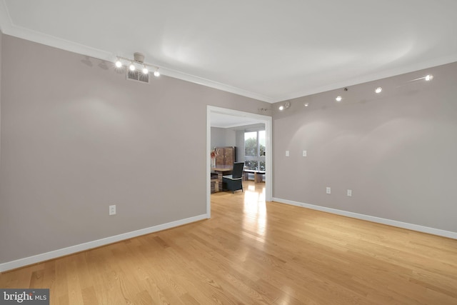 unfurnished room featuring light hardwood / wood-style floors and crown molding