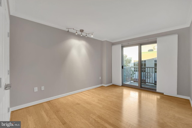 empty room featuring light hardwood / wood-style floors and ornamental molding