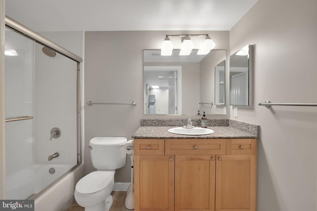 full bathroom with tile patterned floors, vanity, toilet, and enclosed tub / shower combo