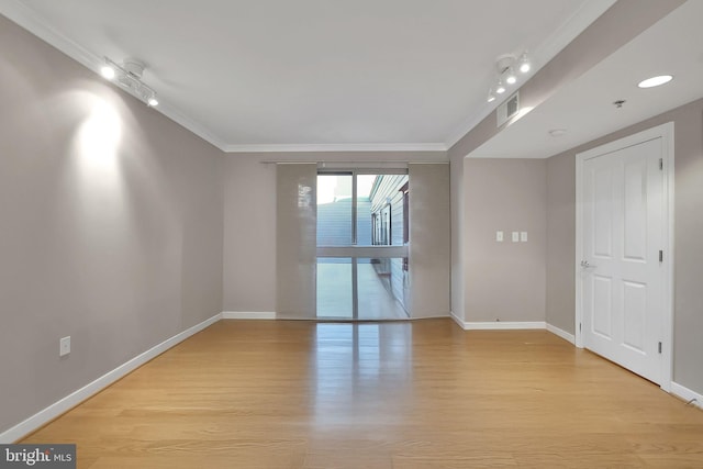 unfurnished room with light hardwood / wood-style flooring and crown molding