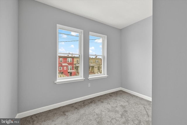 spare room featuring light colored carpet