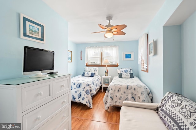 bedroom with ceiling fan and light hardwood / wood-style floors