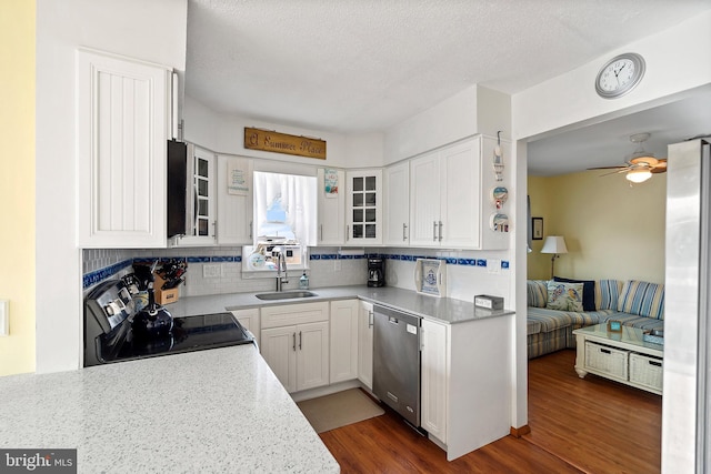 kitchen featuring decorative backsplash, appliances with stainless steel finishes, dark wood-type flooring, sink, and white cabinetry