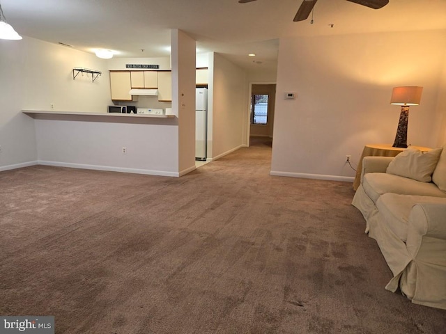 carpeted living room with ceiling fan