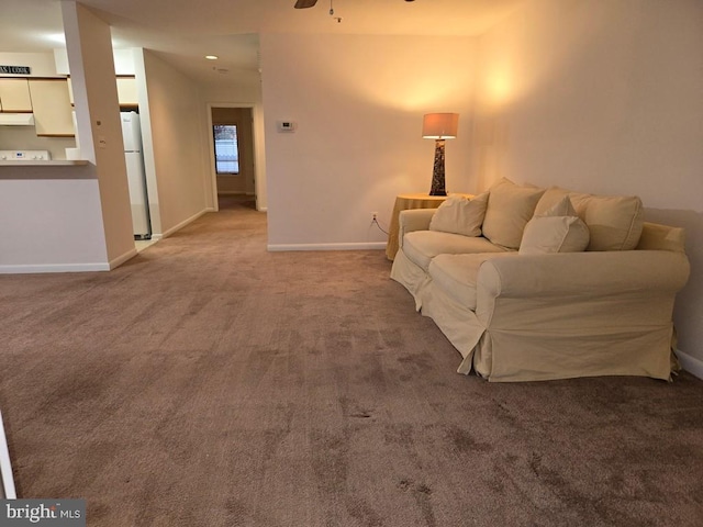 living room featuring ceiling fan and carpet floors