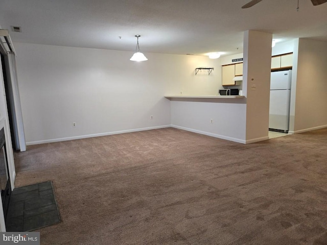 unfurnished living room with carpet floors and ceiling fan