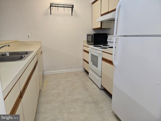 kitchen with sink and white appliances