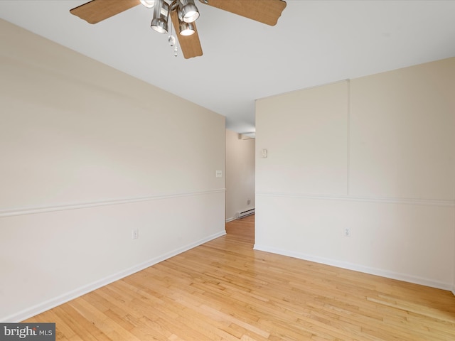 empty room featuring light hardwood / wood-style flooring, ceiling fan, and baseboard heating