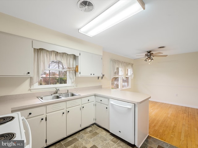 kitchen featuring sink, white cabinetry, ceiling fan, kitchen peninsula, and white appliances