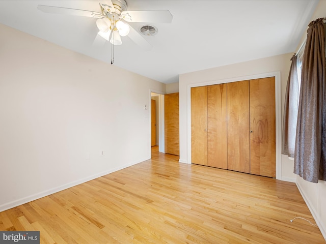 unfurnished bedroom with ceiling fan, a closet, and light hardwood / wood-style flooring