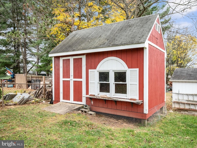 view of outbuilding featuring a yard