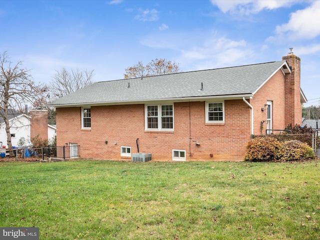 back of house with a lawn and central air condition unit