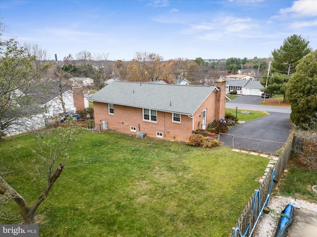 rear view of property with a yard