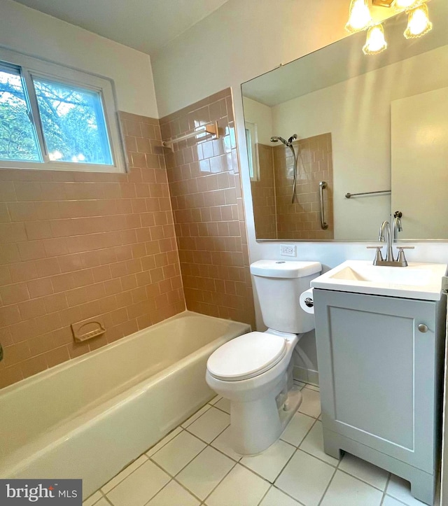 full bathroom featuring tile patterned flooring, vanity, toilet, and tiled shower / bath