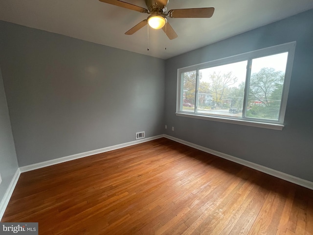 spare room featuring hardwood / wood-style flooring and ceiling fan