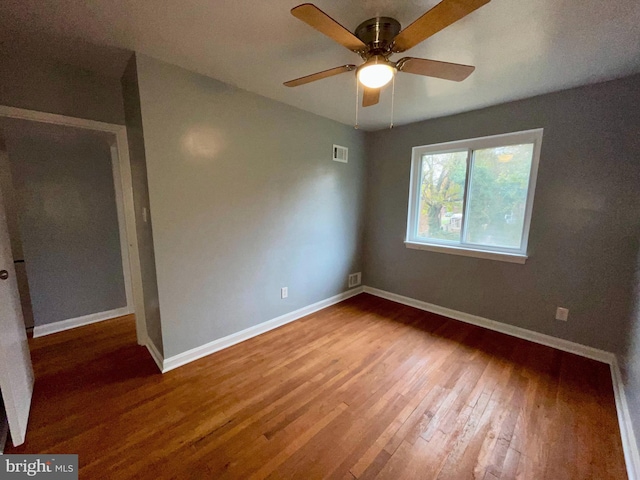 spare room with ceiling fan and hardwood / wood-style floors