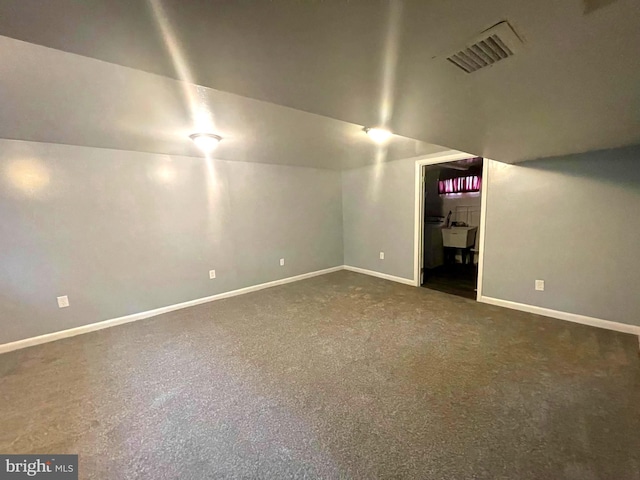 interior space with dark colored carpet and sink