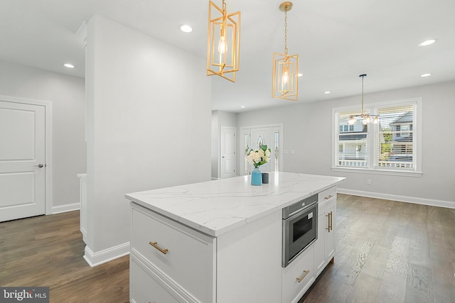 kitchen with dark hardwood / wood-style flooring, white cabinets, pendant lighting, and an inviting chandelier