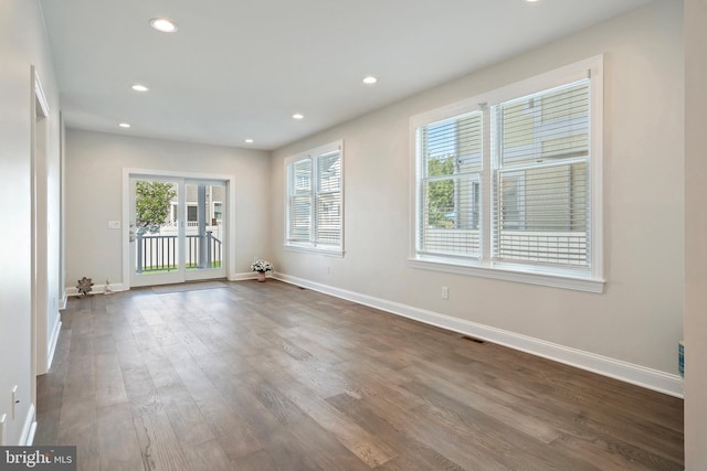 spare room with dark hardwood / wood-style floors