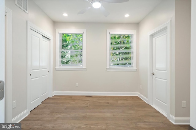 unfurnished bedroom with a closet, ceiling fan, and hardwood / wood-style floors