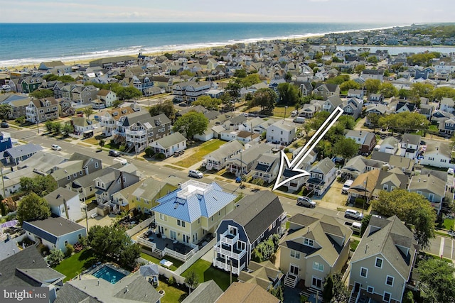 bird's eye view featuring a view of the beach and a water view