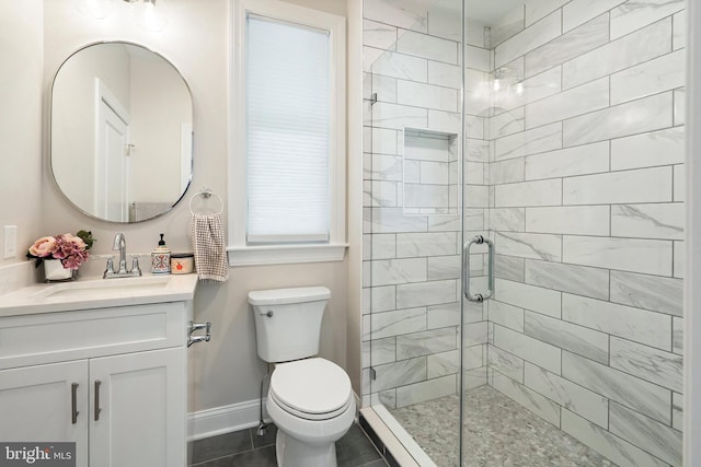 bathroom with tile patterned flooring, vanity, an enclosed shower, and toilet