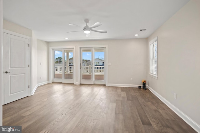 spare room featuring hardwood / wood-style floors and ceiling fan